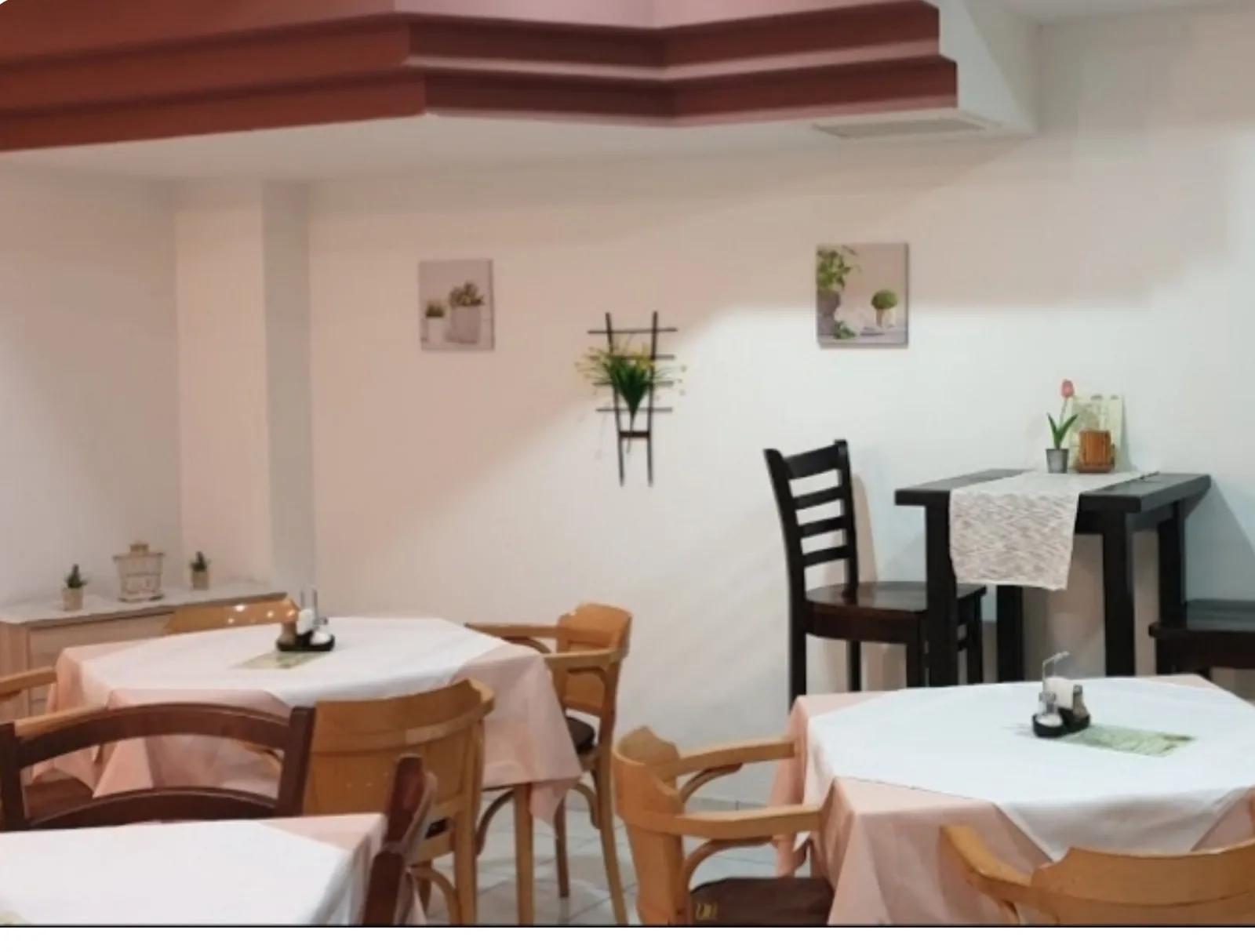 Unutrašnjost bistroa sa stolovima i stolicama